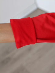 Red off shoulder mini dress sleeve cuff close up showing fitted cuff and fabric