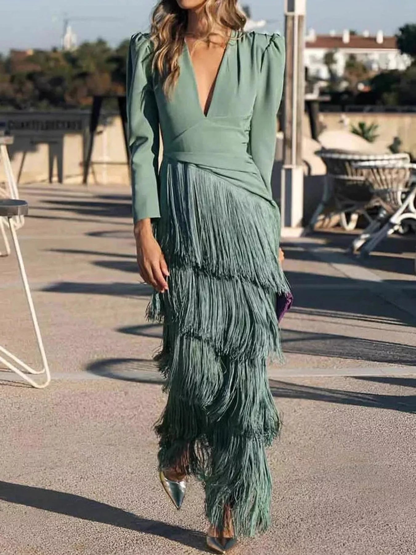 Full length front view of a gum leaf green fringed maxi dress worn walking outdoors