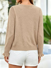 Back view of khaki ruffle trimmed knit cardigan with ruffled cuffs and white shorts