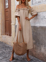 Women's tan off-shoulder midi dress with ruffled neckline and puff sleeves, styled on model wearing a straw hat.
