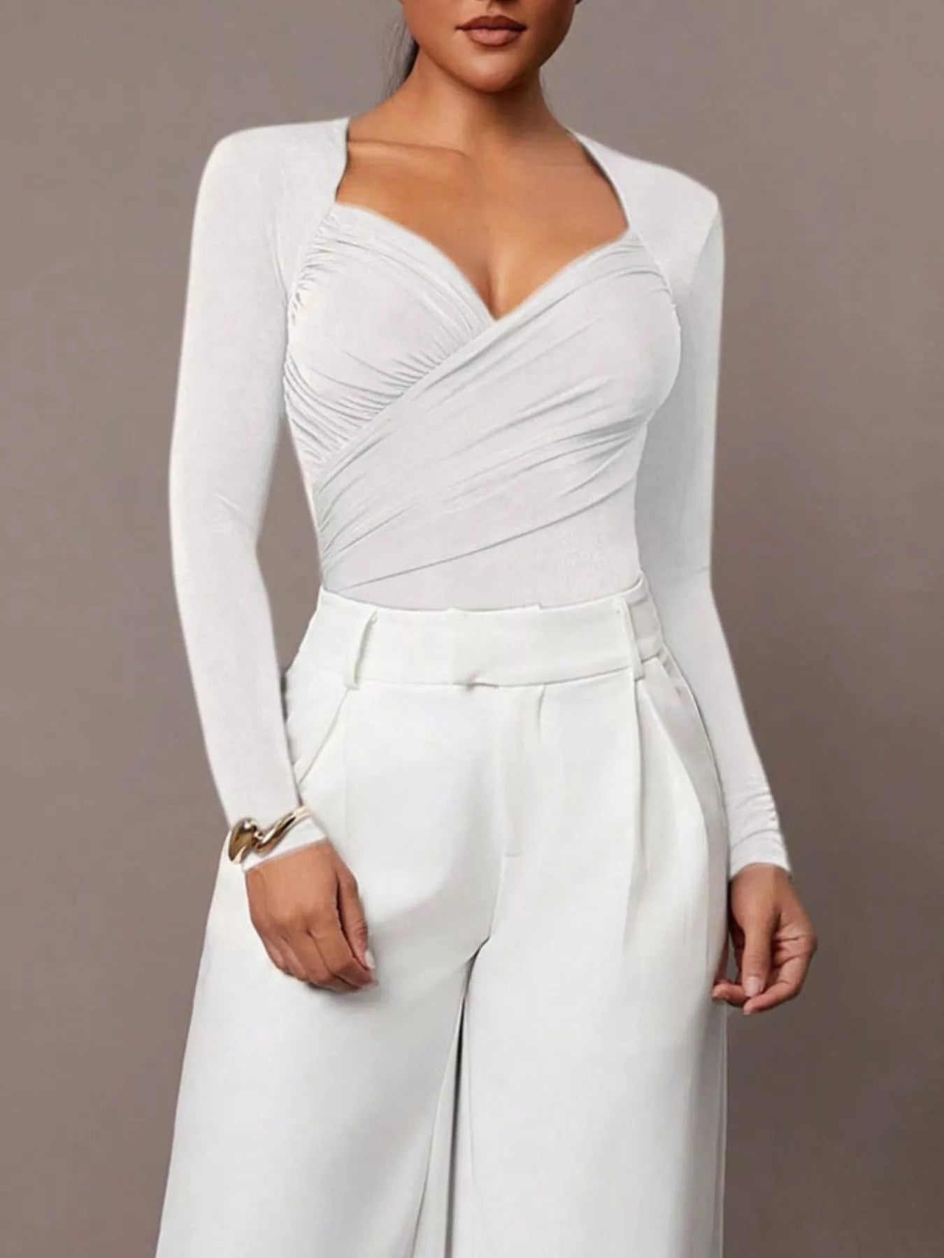 White ruched surplice long sleeve bodysuit worn with white wide leg trousers, full front view