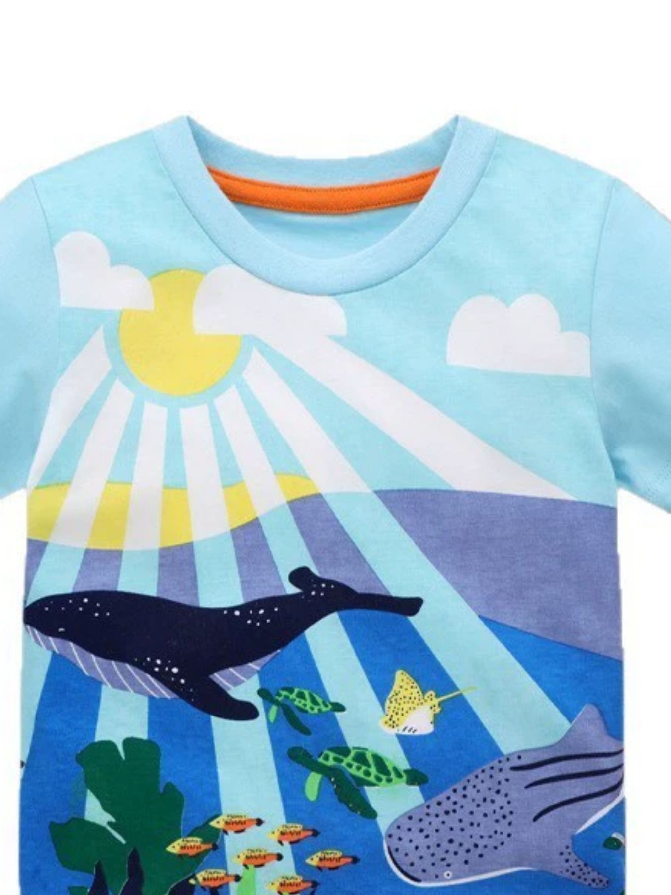 Close-up of the pastel blue children's t-shirt neckline with orange trim and sunlit ocean print