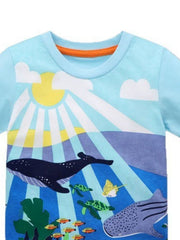 Close-up of the pastel blue children's t-shirt neckline with orange trim and sunlit ocean print
