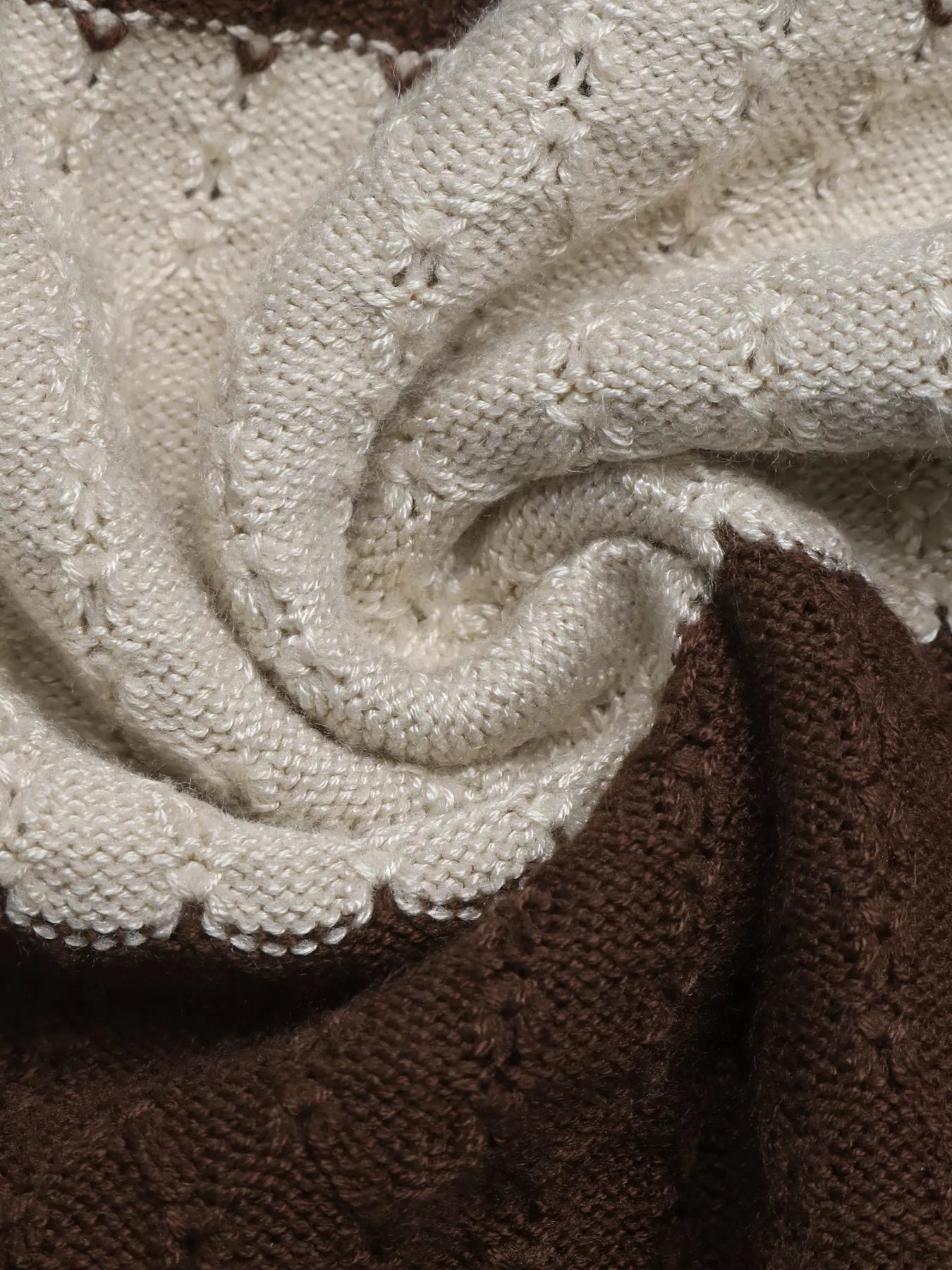 Close up of the soft cream and brown textured knit fabric on the striped top