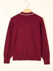 Back view of the burgundy knit cardigan on a hanger showing collar trim