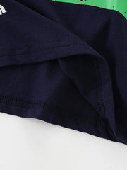 Close-up of the hem stitching and inner fabric on a black children's dinosaur graphic T-shirt