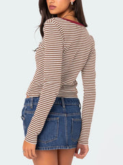 Back view of brown and white striped long sleeve t shirt with deep red neckline trim worn on model