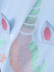 Angled close-up of the glitter unicorn horn and applique ears on the sky blue tee