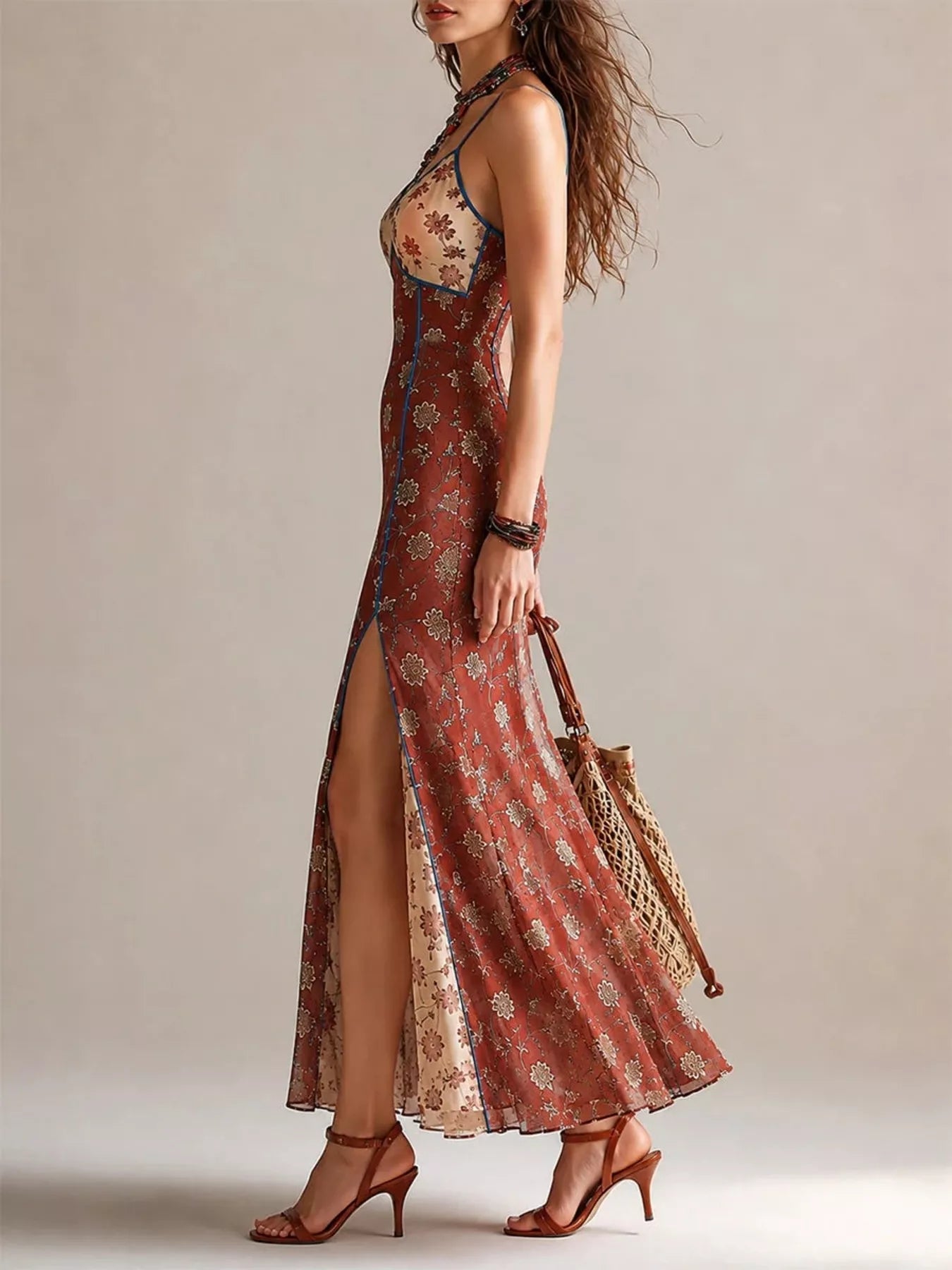 Side profile of rust floral spaghetti strap maxi dress showing high slit and flowing skirt