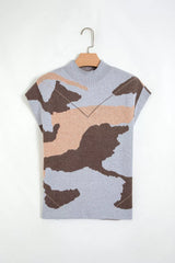 Flat lay of a gray, brown, and tan camouflage knit top on a hanger.