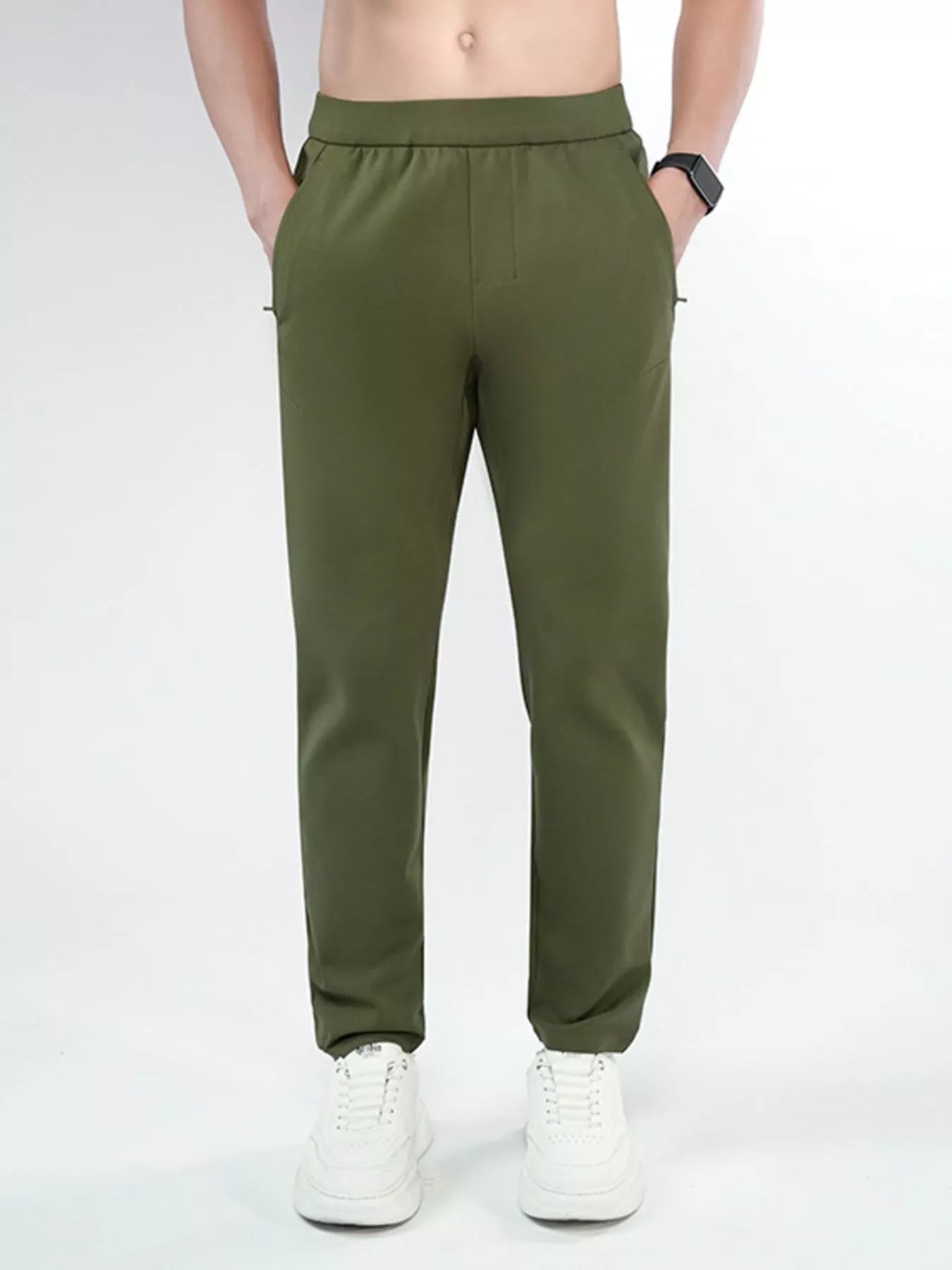 Men's army green slim-fit pants with a drawstring waist and pockets.