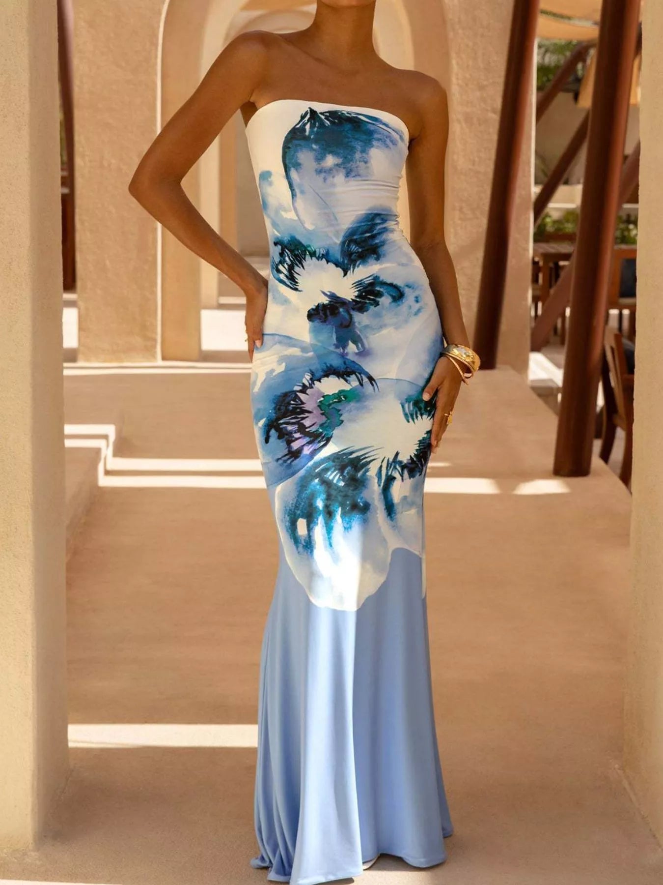 Model wearing strapless light blue and white floral tube maxi dress, front view outdoors