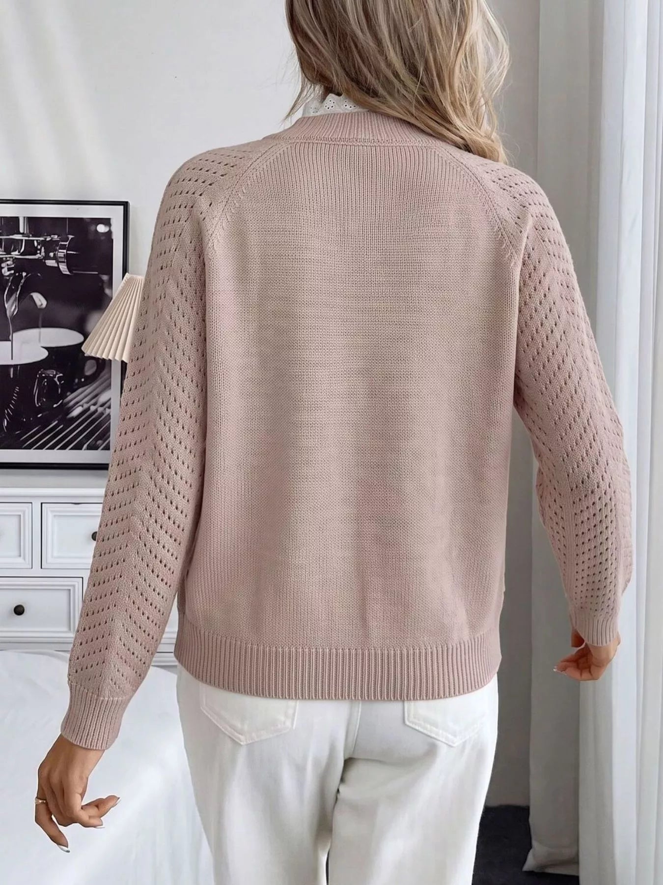Back view of a pink mock neck sweater with plain back and openwork long sleeves
