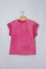 Pink mineral-wash top with raw seam details and lace-trimmed cap sleeves on a hanger