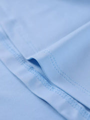 Close view of light blue hem stitching on a ruched spaghetti strap bodycon maxi dress
