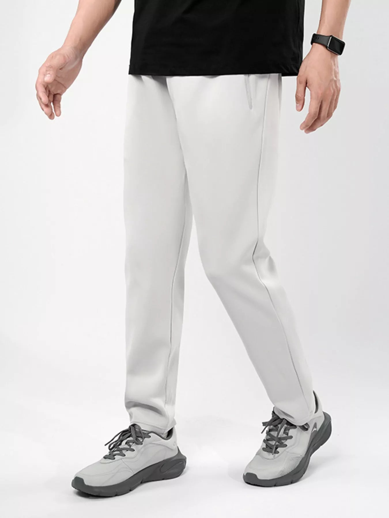 Men's plus-size stretch pants in light gray with an elastic waist and zipper pockets.
