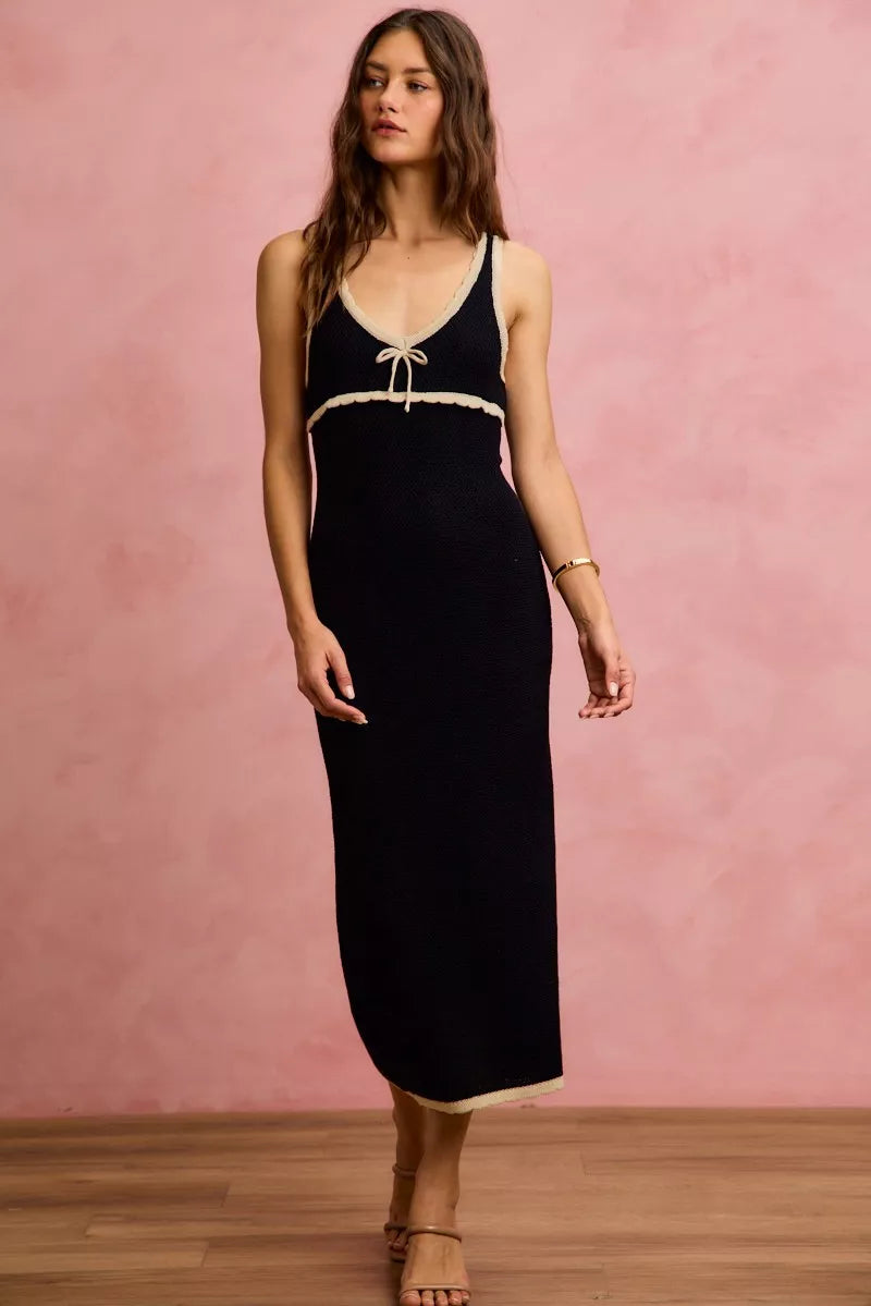 Black and oatmeal sleeveless knit sweater maxi dress in front walking view