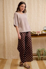 Full length front view of washed mocha dolman knit top, standing with hands down.