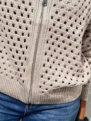 Close up of the pale beige crochet cardigan lower zip and ribbed hem