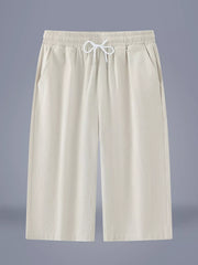 Men's ivory cropped casual pants with a drawstring waist and pockets.