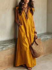 Gold sleeveless button down linen maxi dress worn front facing with woven tote bag