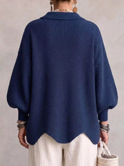 Back view of the navy knit cardigan with lantern sleeves and scalloped hem