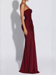 Red strapless sequin corset maxi dress on model, full length side profile in studio