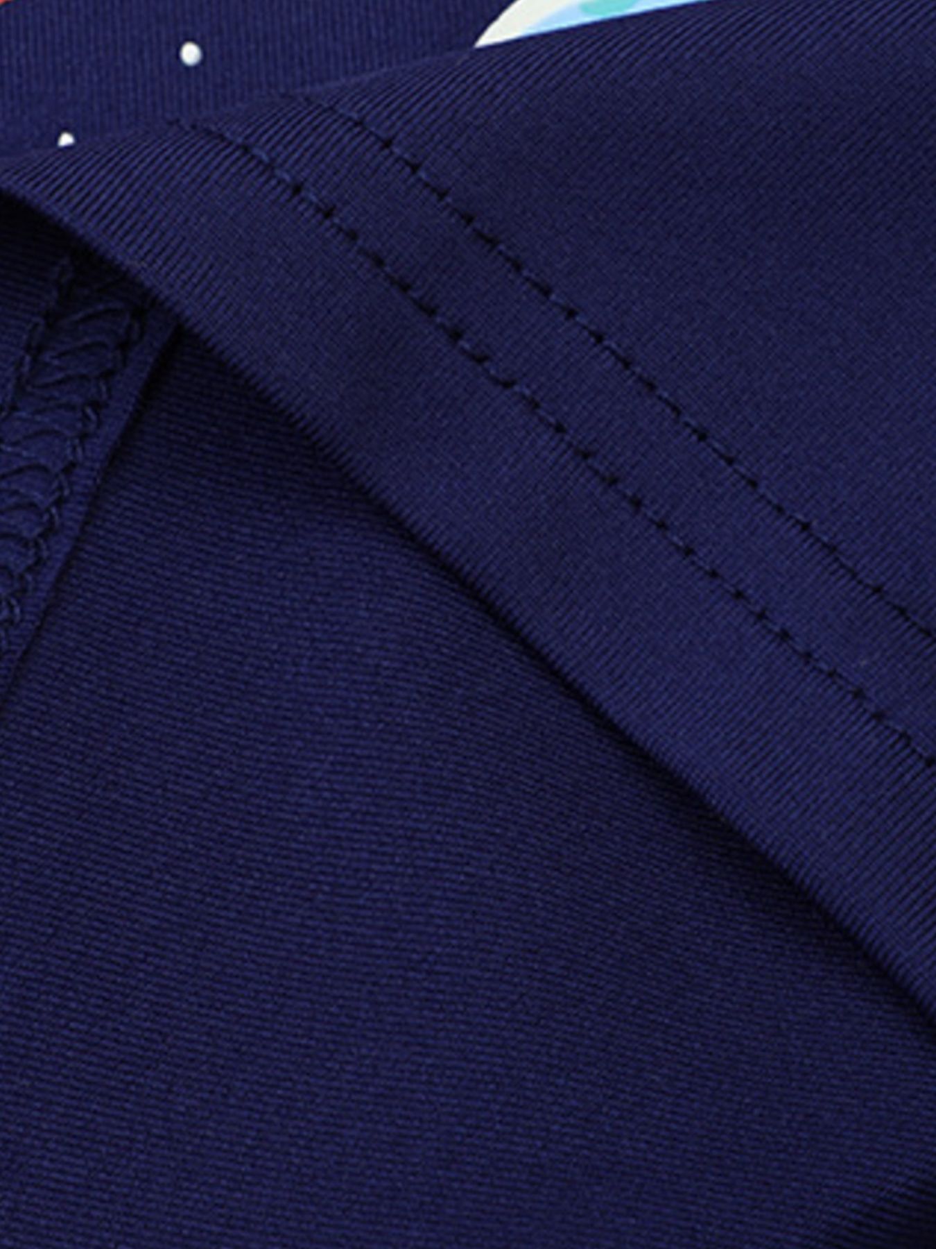 Close view of the navy children's tee fabric and double stitched seam in a folded detail