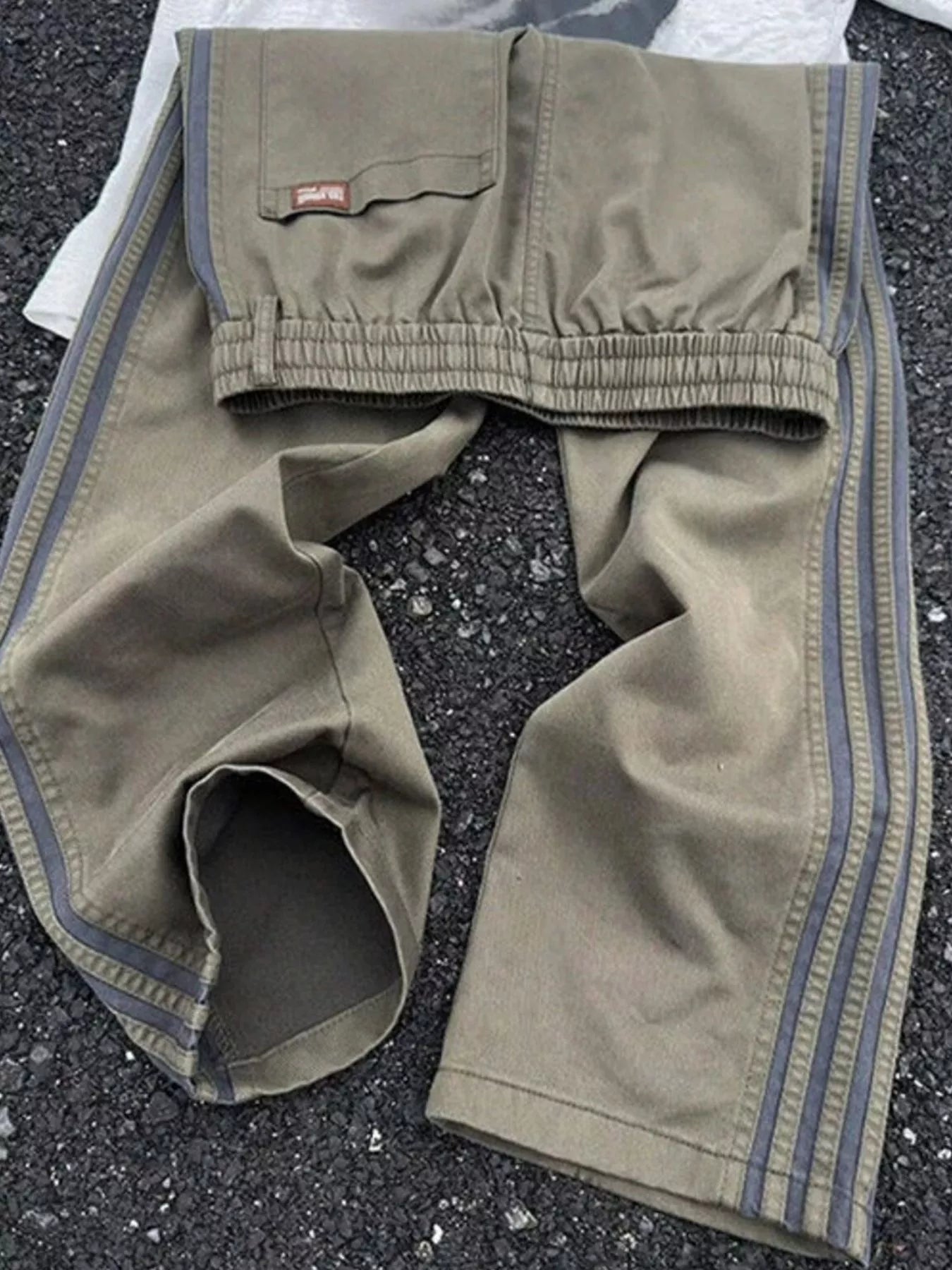 Men's striped wide leg pants with a drawstring waist and pockets.