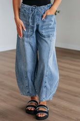 Women's wide-leg jeans with a drawstring waistband and pockets.