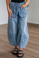 Women's wide-leg jeans with a drawstring waistband and pockets.