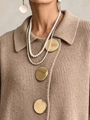 Close up of the khaki cardigan collar and large gold front buttons