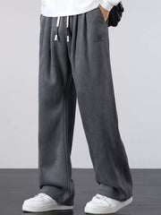 Men's gray lightweight loose-fit pants with a drawstring waist and pockets.