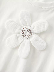 Close-up of padded white flower applique with stitched starburst center on white t-shirt