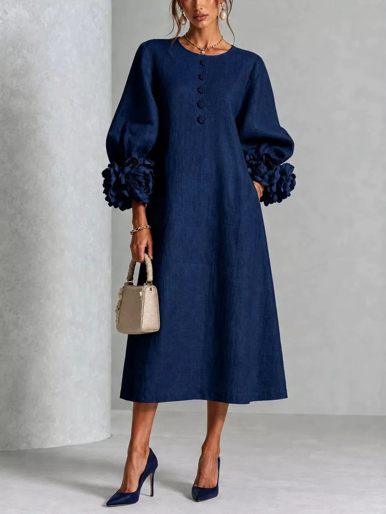 Navy round neck midi dress with balloon sleeves, floral cuffs and small floral buttons, front view