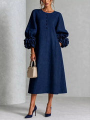 Navy round neck midi dress with balloon sleeves, floral cuffs and small floral buttons, front view