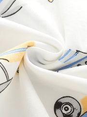 Close-up of the soft white cotton fabric with a car wheel and vehicle print detail