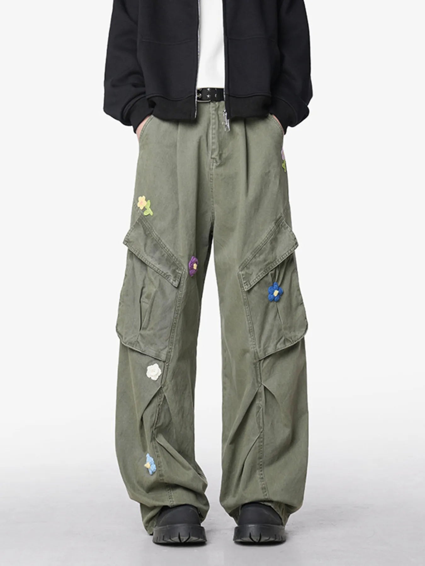 Men's green wide-leg pants with an oversized fit and pockets.
