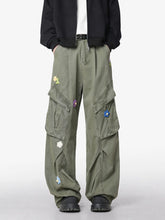 Men's green wide-leg pants with an oversized fit and pockets.