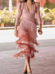 Full length view of a pink fringed maxi dress with puff sleeves worn walking outdoors