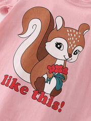 Angled close-up of squirrel holding red flowers on blush pink children's short sleeve t-shirt