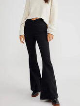 Women's black flare jeans with an asymmetric waist and slightly stretchy fabric.
