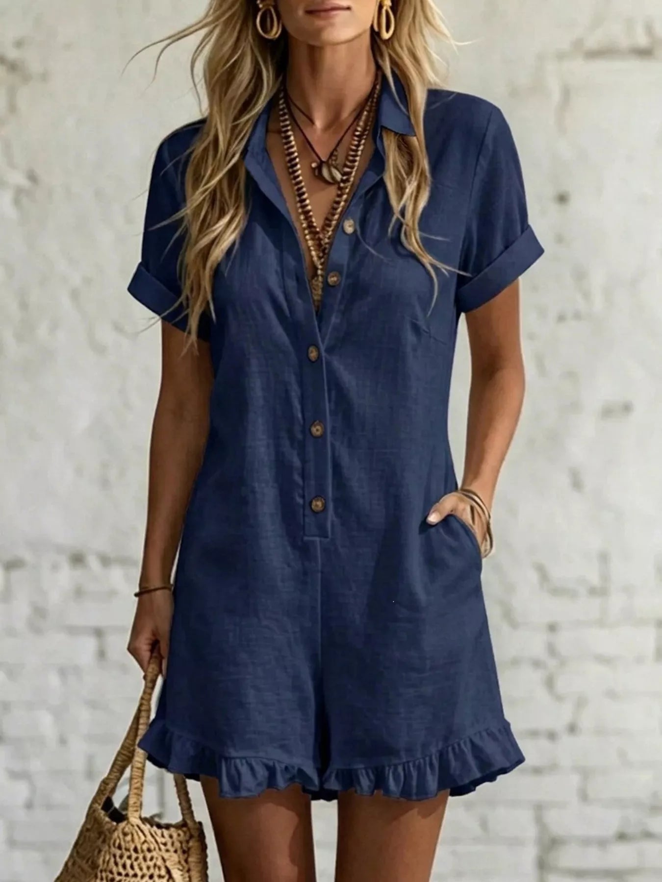 Women's button-front romper with a ruffled hem and pockets.