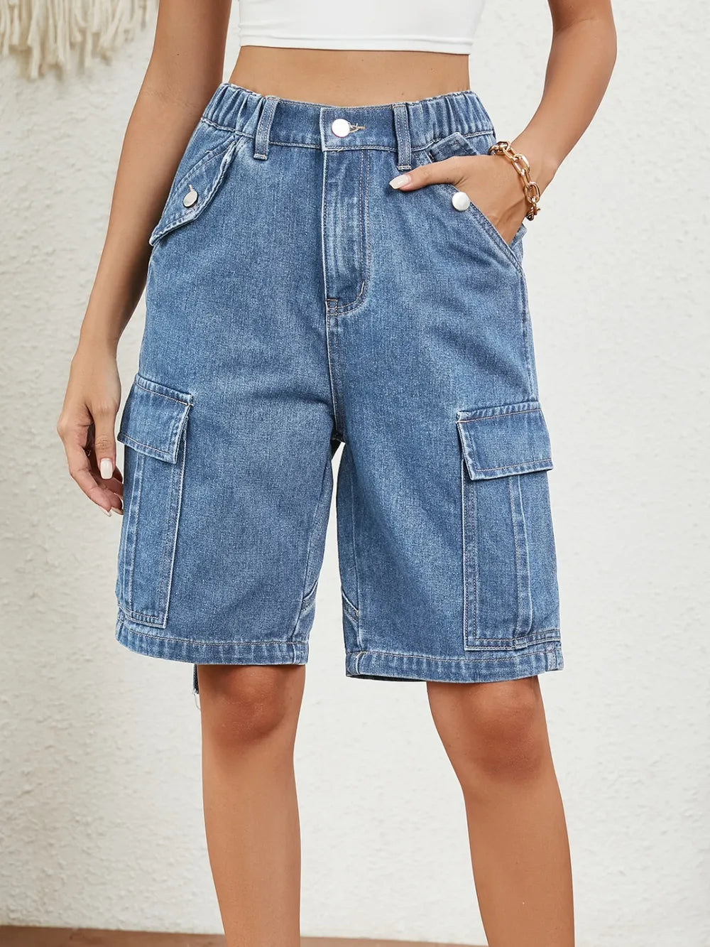 Women's denim shorts with an elastic waist, buttons, and pockets.
