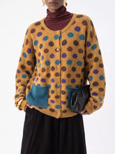 Mustard polka dot cardigan with buttons and teal pockets on model