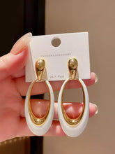 Contemporary Gold Tone Drop Earrings with Elongated White Smooth Oval Inlay