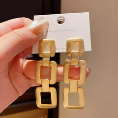 Contemporary Gold Tone Drop Earrings with Interlocking Geometric Links