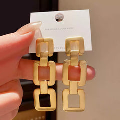Contemporary Gold Tone Drop Earrings with Interlocking Geometric Links