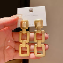 Contemporary Gold Tone Drop Earrings with Interlocking Geometric Links