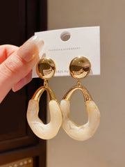 Stylish Gold Tone Drop Earrings with Round Top and Irregular Creamy White Geometric Inset